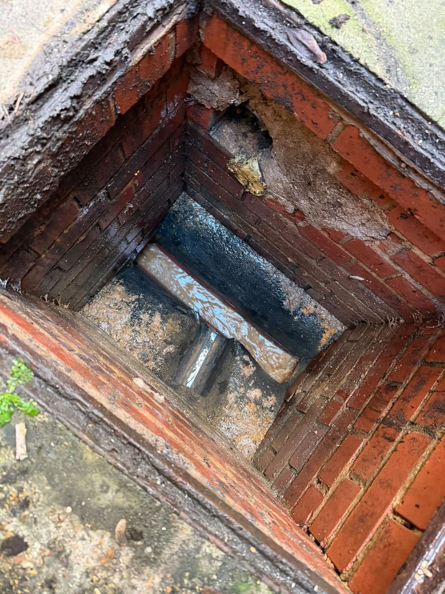 Brick manhole flooded to the brim: after