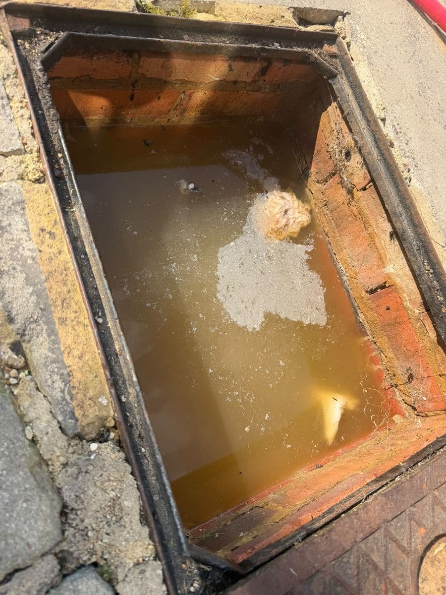 Inspection chamber backed up with dirty water: before